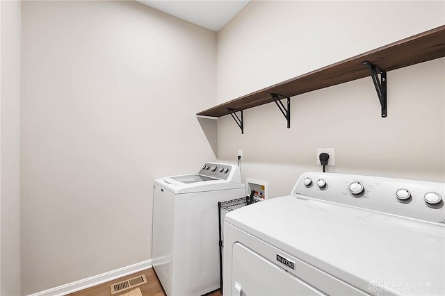 1691 Arden Bnd, Fairborn, OH 45324 - laundry area with separate washer and dryer, baseboards, and light wood-type flooring