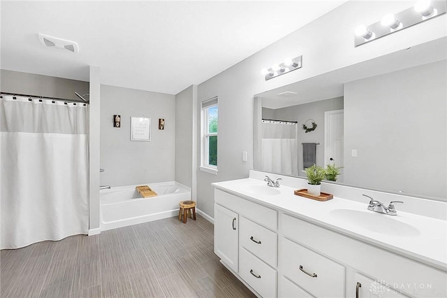 1691 Arden Bnd, Fairborn, OH 45324 - bathroom with double vanity, a bath, baseboards, and a shower with shower curtain