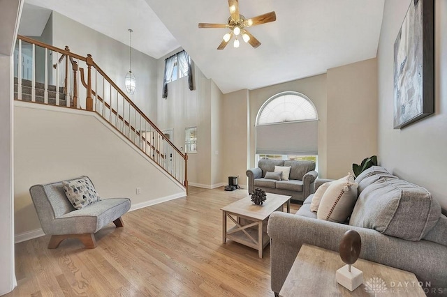 406 Forge Dr, Lebanon, OH 45036 - living room featuring stairs, high vaulted ceiling, a ceiling fan, wood finished floors, and baseboards