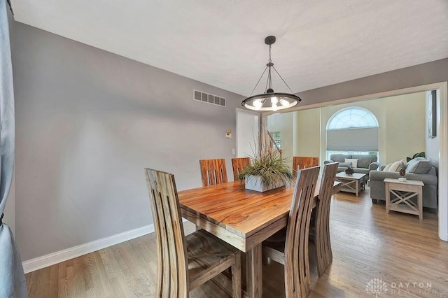 406 Forge Dr, Lebanon, OH 45036 - dining room featuring light wood-style floors, baseboards, and a chandelier