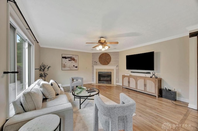 406 Forge Dr, Lebanon, OH 45036 - living area featuring ceiling fan, light wood-style floors, baseboards, ornamental molding, and a fireplace with flush hearth