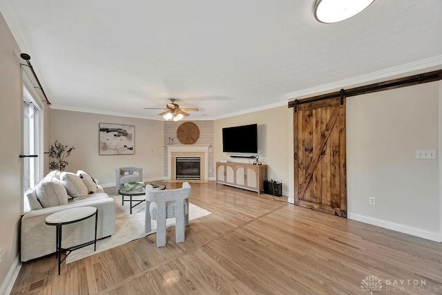 406 Forge Dr, Lebanon, OH 45036 - living room with a ceiling fan, light wood finished floors, baseboards, a barn door, and a brick fireplace