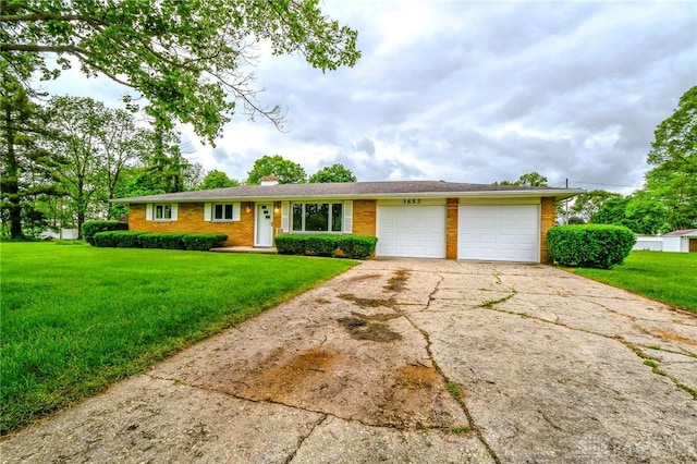 3653 Cloverdale Rd, Medway, OH 45341 - ranch-style house with a garage, a front yard, brick siding, and driveway