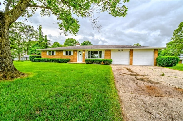 3653 Cloverdale Rd, Medway, OH 45341 - ranch-style home with an attached garage, brick siding, driveway, a front lawn, and a chimney