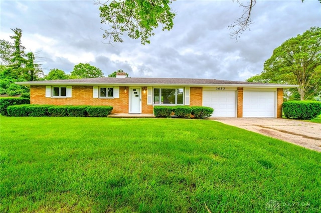 3653 Cloverdale Rd, Medway, OH 45341 - ranch-style home with an attached garage, a front yard, brick siding, concrete driveway, and a chimney