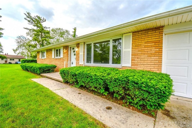 3653 Cloverdale Rd, Medway, OH 45341 - view of front of house with brick siding, a front lawn, and a garage