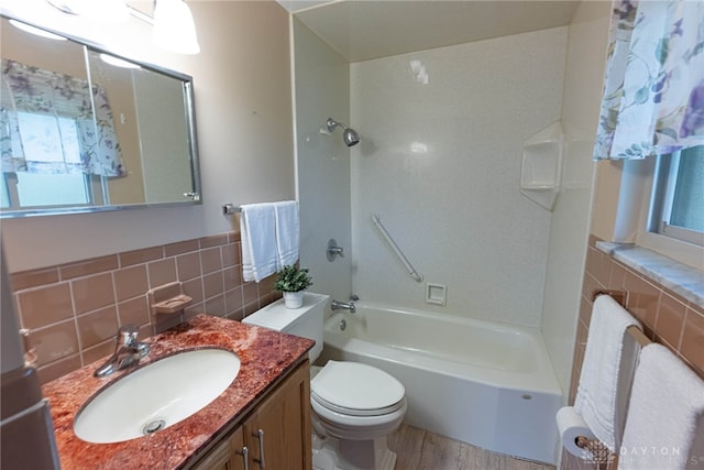 2444 Tennyson Dr, Bellbrook, OH 45305 - bathroom with tile walls, bathtub / shower combination, vanity, toilet, and wood finished floors