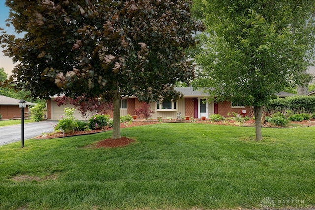 2444 Tennyson Dr, Bellbrook, OH 45305 - view of front of property featuring asphalt driveway, a front lawn, brick siding, and a garage