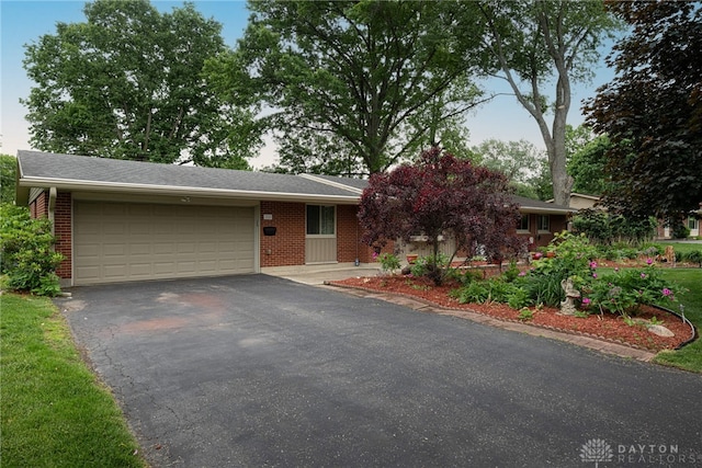2444 Tennyson Dr, Bellbrook, OH 45305 - view of front of home featuring a garage, asphalt driveway, and brick siding