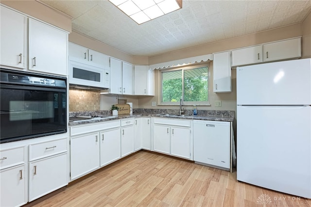 2444 Tennyson Dr, Bellbrook, OH 45305 - kitchen with white appliances, a sink, light wood-style floors, tasteful backsplash, and white cabinets