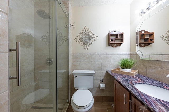 2444 Tennyson Dr, Bellbrook, OH 45305 - full bath with vanity, tile walls, toilet, a shower stall, and a wainscoted wall