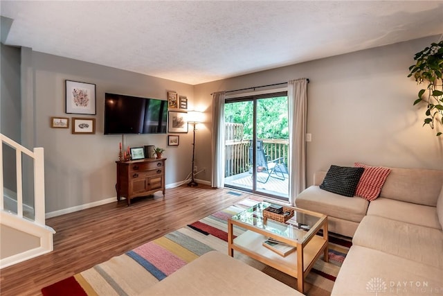 9492 Colegate Way, West Chester, OH 45011 - living area featuring baseboards, wood finished floors, stairs, and a textured ceiling