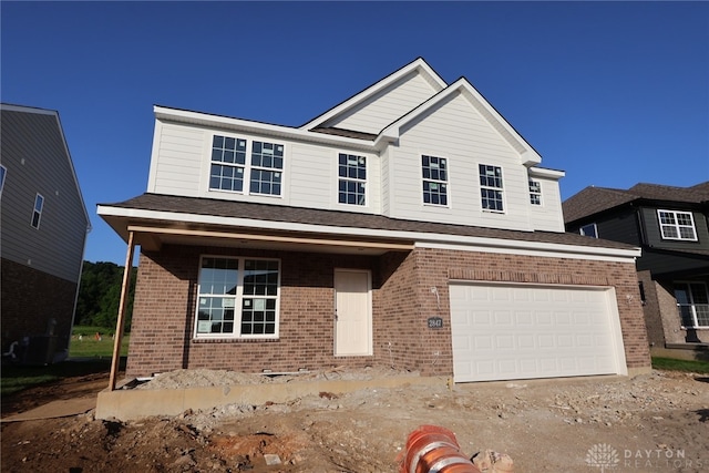 2847 Sky Crossing Dr Unit 0048, Beavercreek, OH 45434 - traditional-style home featuring brick siding, an attached garage, and driveway
