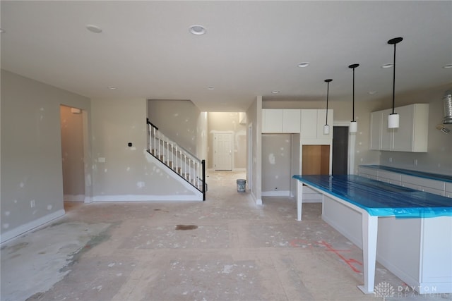 2847 Sky Crossing Dr Unit 0048, Beavercreek, OH 45434 - kitchen with white cabinets, pendant lighting, dark countertops, and a kitchen island