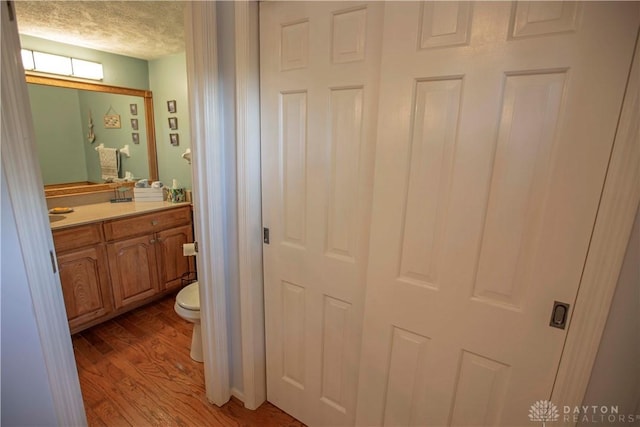 40 Nicholson Ct, Washington Twp, OH 45459 - bathroom featuring wood finished floors, vanity, and toilet