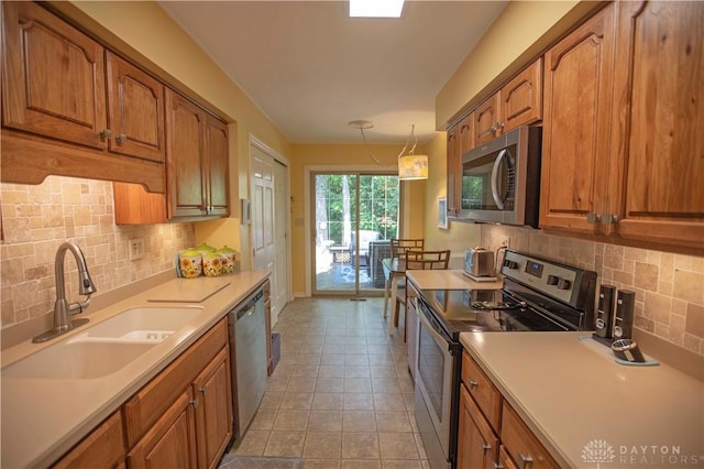 40 Nicholson Ct, Washington Twp, OH 45459 - kitchen featuring stainless steel appliances, a sink, and brown cabinetry