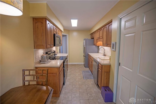 40 Nicholson Ct, Washington Twp, OH 45459 - kitchen featuring appliances with stainless steel finishes, a sink, backsplash, and light countertops