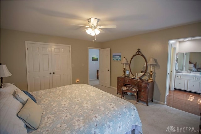 40 Nicholson Ct, Washington Twp, OH 45459 - bedroom featuring light carpet, a closet, ceiling fan, baseboards, and ensuite bath
