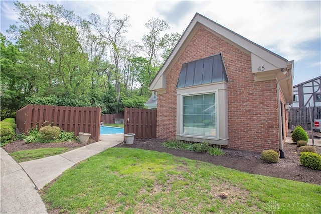 40 Nicholson Ct, Washington Twp, OH 45459 - view of home's exterior featuring brick siding and a standing seam roof