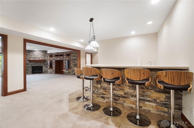 7721 Country Brook Ct, Springboro, OH 45066 - indoor wet bar with light carpet, recessed lighting, hanging light fixtures, a fireplace, and baseboards