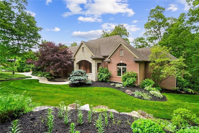 7721 Country Brook Ct, Springboro, OH 45066 - view of front of home featuring stone siding, a front lawn, brick siding, and roof with shingles