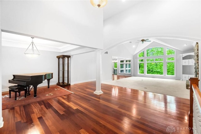 7721 Country Brook Ct, Springboro, OH 45066 - unfurnished living room with vaulted ceiling, arched walkways, a ceiling fan, wood finished floors, and ornate columns