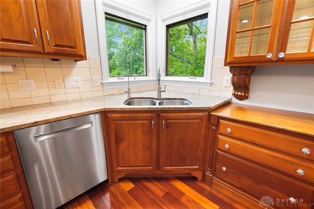 7721 Country Brook Ct, Springboro, OH 45066 - kitchen featuring dishwasher, a sink, dark wood finished floors, light stone countertops, and glass insert cabinets