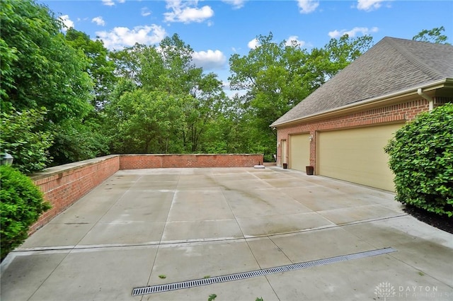 7721 Country Brook Ct, Springboro, OH 45066 - view of side of property with brick siding, a shingled roof, and an attached garage