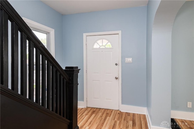 1015 Maiden Ln, Springfield, OH 45504 - foyer featuring arched walkways, light wood finished floors, stairs, and baseboards