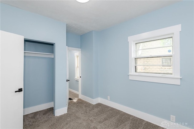 1015 Maiden Ln, Springfield, OH 45504 - unfurnished bedroom with carpet flooring, a closet, and baseboards