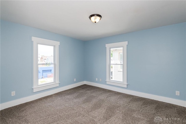 1015 Maiden Ln, Springfield, OH 45504 - unfurnished room with dark colored carpet and baseboards
