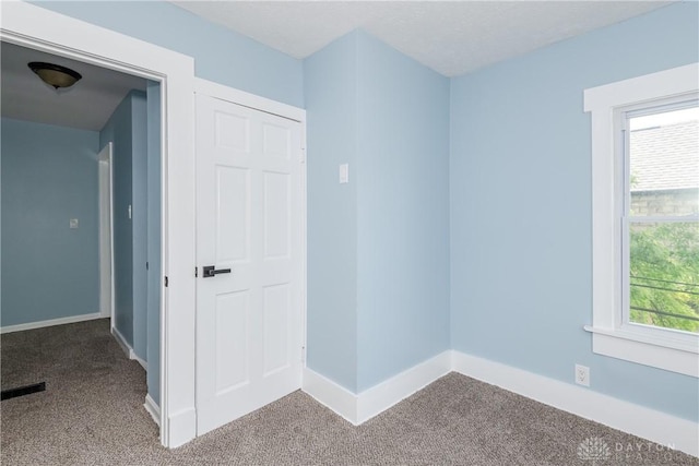 1015 Maiden Ln, Springfield, OH 45504 - carpeted empty room featuring baseboards