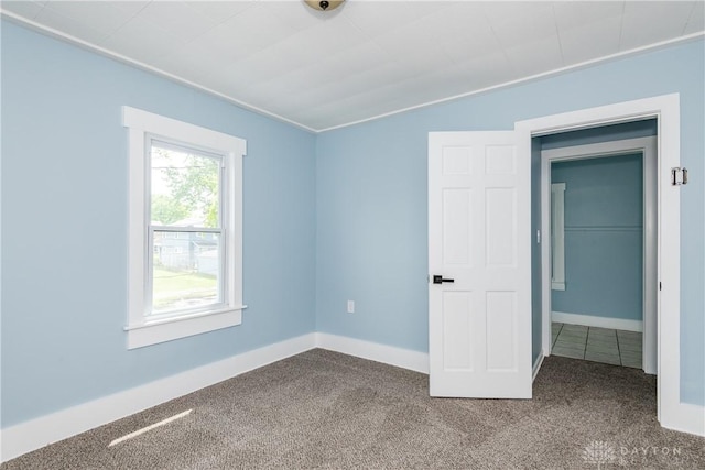 1015 Maiden Ln, Springfield, OH 45504 - unfurnished bedroom with dark carpet and baseboards