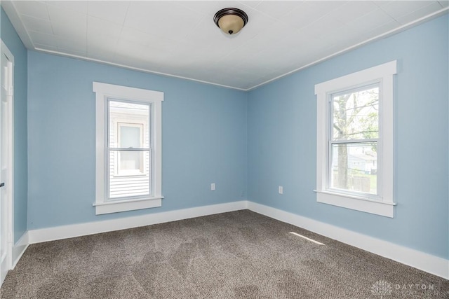 1015 Maiden Ln, Springfield, OH 45504 - empty room with dark carpet, plenty of natural light, and baseboards