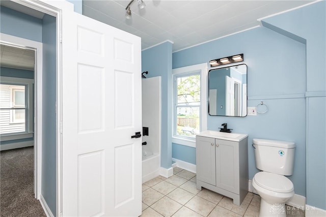 1015 Maiden Ln, Springfield, OH 45504 - bathroom with shower / washtub combination, vanity, toilet, tile patterned flooring, and baseboards