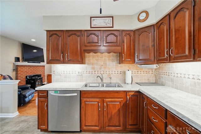 601 Tara Oaks Dr, Middletown, OH 45042 - kitchen featuring stainless steel dishwasher, a sink, light countertops, decorative backsplash, and light tile patterned floors