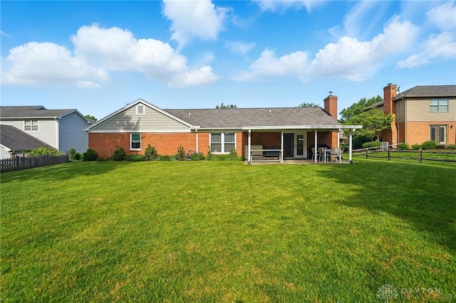 601 Tara Oaks Dr, Middletown, OH 45042 - rear view of house with brick siding, a chimney, and a patio area