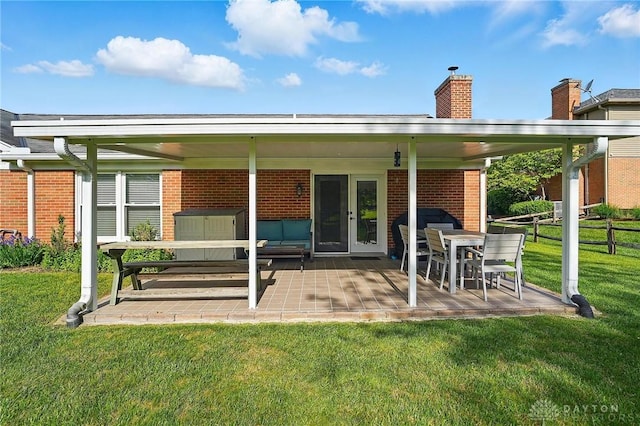 601 Tara Oaks Dr, Middletown, OH 45042 - back of house featuring brick siding, a patio, and a chimney