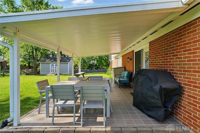 601 Tara Oaks Dr, Middletown, OH 45042 - view of patio / terrace with outdoor dining area, a grill, and an outbuilding