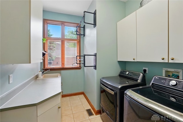 1129 Green Tree Rd, Centerville, OH 45429 - washroom featuring cabinet space, washing machine and clothes dryer, baseboards, and light tile patterned flooring