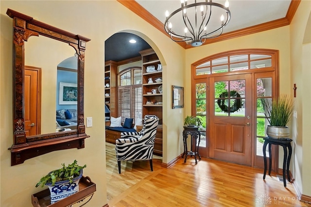 1129 Green Tree Rd, Centerville, OH 45429 - entrance foyer with arched walkways, plenty of natural light, light wood-style flooring, crown molding, and a chandelier