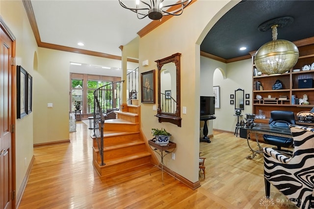 1129 Green Tree Rd, Centerville, OH 45429 - foyer entrance featuring arched walkways, crown molding, a chandelier, light wood-style flooring, and baseboards