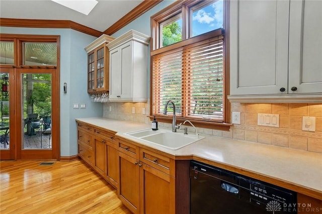 1129 Green Tree Rd, Centerville, OH 45429 - kitchen featuring dishwasher, a sink, a skylight, light countertops, and healthy amount of natural light
