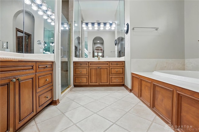 1129 Green Tree Rd, Centerville, OH 45429 - full bathroom featuring two vanities, tile patterned floors, a stall shower, and a garden tub