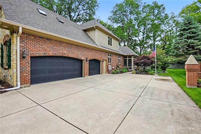 1129 Green Tree Rd, Centerville, OH 45429 - view of home's exterior featuring a shingled roof, driveway, an attached garage, and brick siding