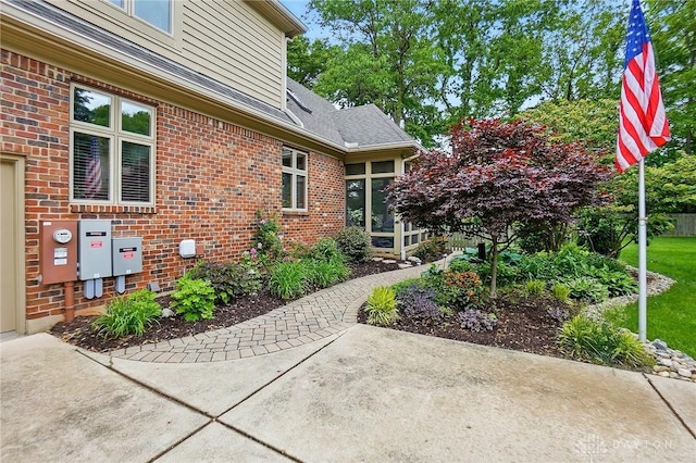 1129 Green Tree Rd, Centerville, OH 45429 - view of exterior entry featuring brick siding and a patio area