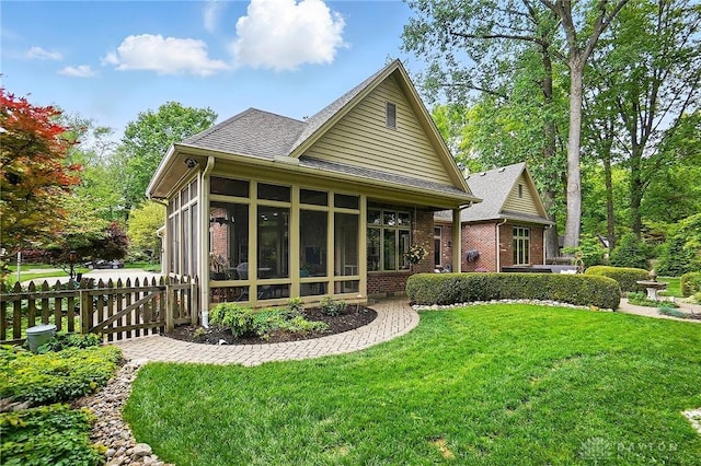 1129 Green Tree Rd, Centerville, OH 45429 - back of property with a sunroom, brick siding, and a shingled roof