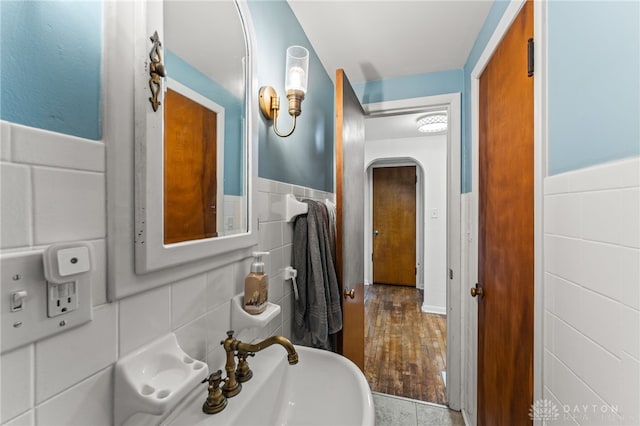 1012 W Sparrow Rd, Springfield, OH 45502 - bathroom featuring tile walls and a wainscoted wall