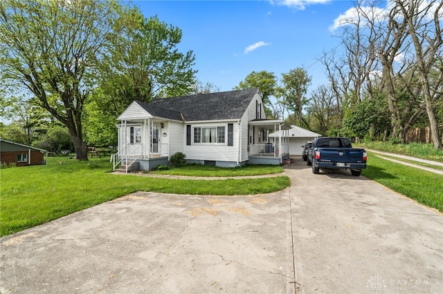 1012 W Sparrow Rd, Springfield, OH 45502 - view of front of house featuring a front lawn, a shingled roof, and driveway