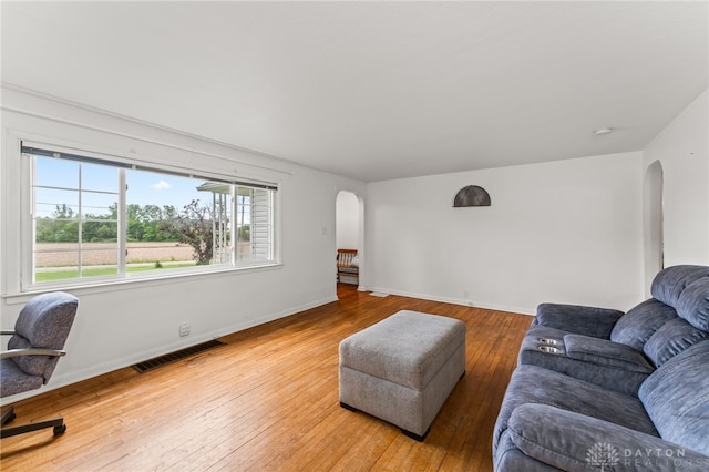 1012 W Sparrow Rd, Springfield, OH 45502 - living area with arched walkways, light wood finished floors, and baseboards